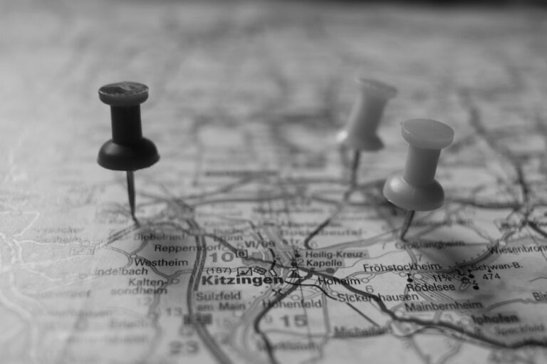 Paper map with location pins placed on it