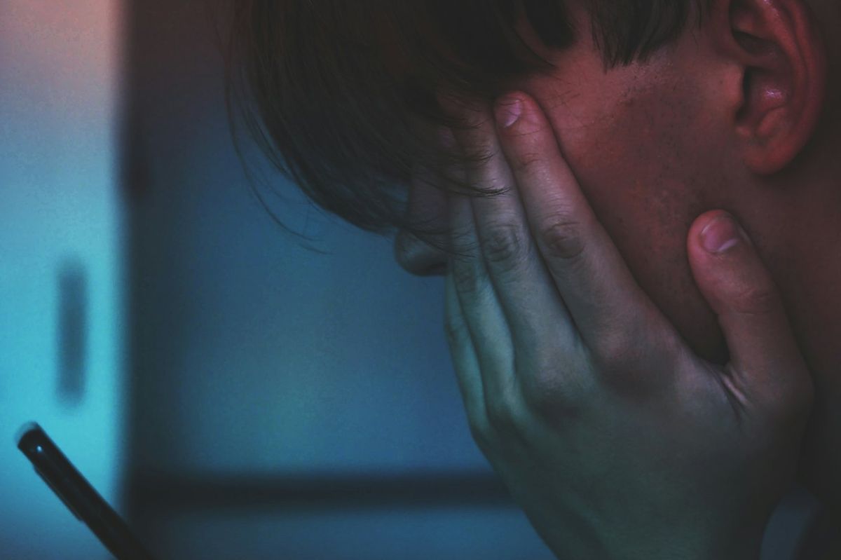 Person holding a smartphone showing an incoming call