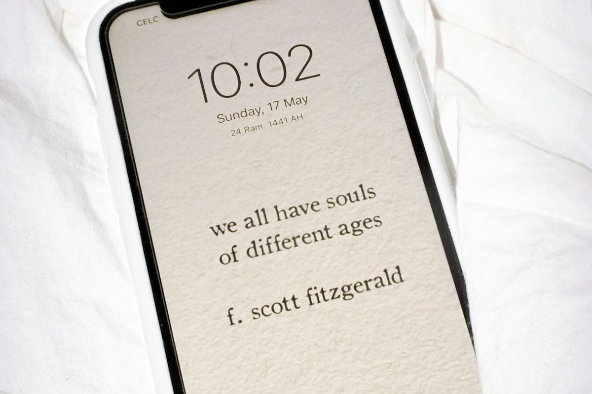 Smartphone lying face up on a white surface