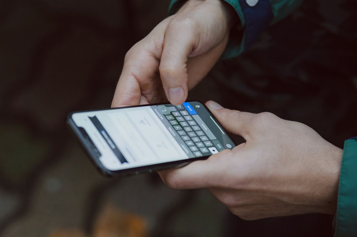 Person typing a short text message on a phone
